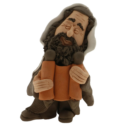 Handcrafted Ceramic figurine portraying a Jewish Rabbi holding a Torah scroll.